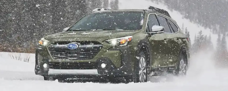 Subaru Outback drives through the snow