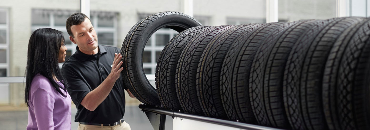 Subaru service representative showing customer a tire. | Subaru City of Milwaukee in Milwaukee WI